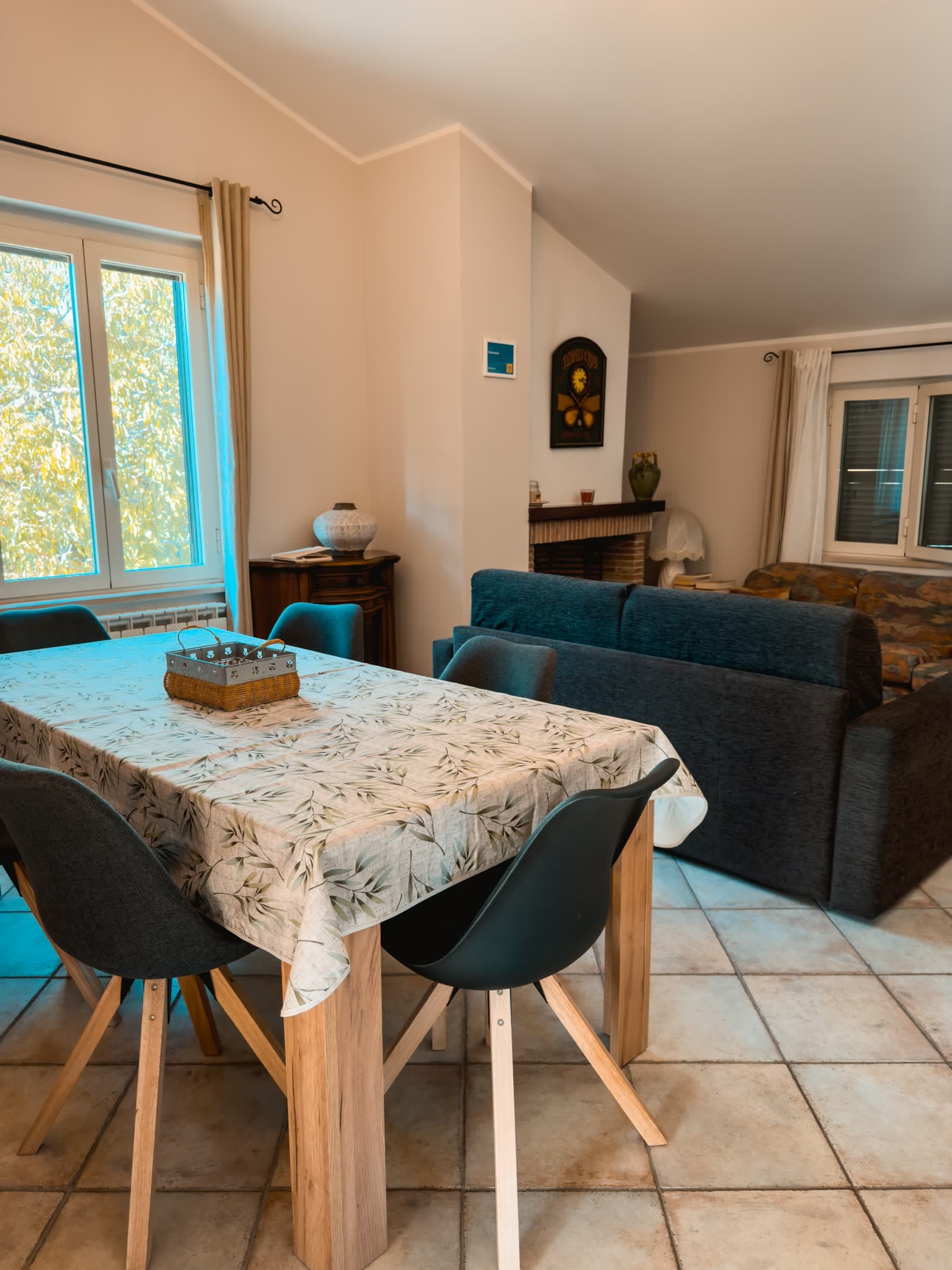 The living room with the table laid, the sofa and the fireplace
